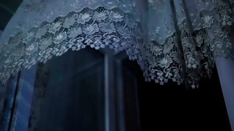 A window curtain swaying in the wind, an open window at night. Stock Footage 248136752