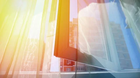 Window with curtains and a view of the sky and city. Conceptual story of the Stock Footage 93651679