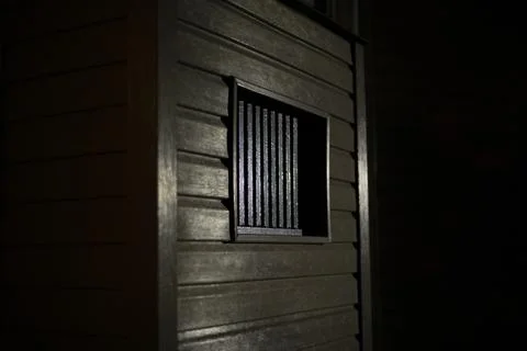 Window in the dark. Lattice on the window to the basement. Stock Photos