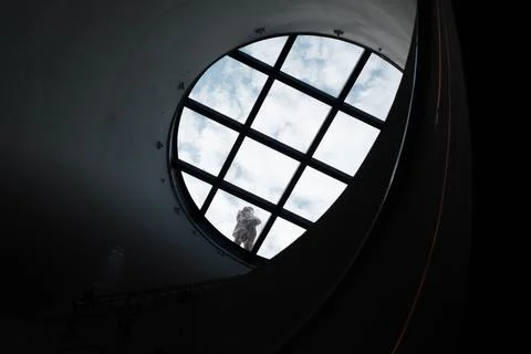 Window in the dark, round glass window in the corridor, floor in the tunnel. Stock Photos