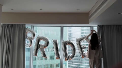 Window is decorated with balloons with the word bride Stock Footage 141978392