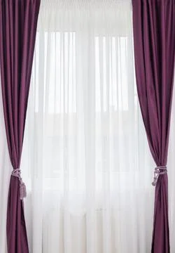 A window with a decorative curtain Stock Photos