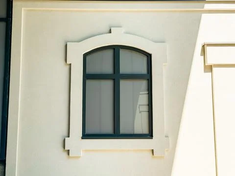 Window with decorative frame design placed on a light-colored building faca.. 写真素材