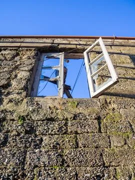 Window in a destroyed building. Remained a wall from the house. The concept.. Stock Photos