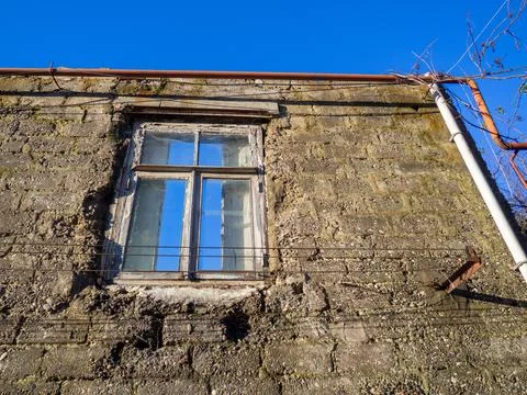 Window in a destroyed building. Remained a wall from the house. The concept.. Stock Photos