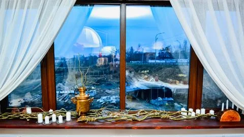 Window display with brass samovar and candles arrangement Stock Photos