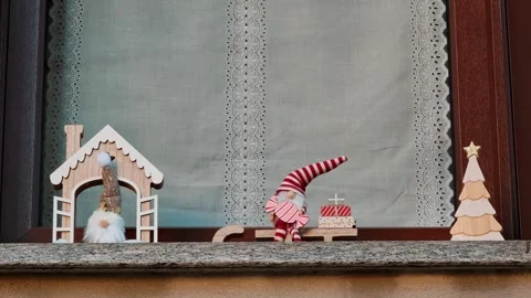 Window display with christmas decorations featuring house, stocking and white Stock Footage 324862124