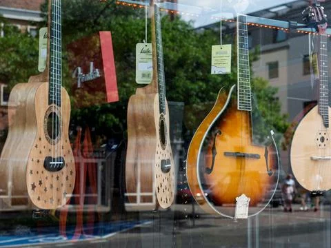 Window Display of Musical Instruments Featuring Ukuleles and Mandolin Stock Photos