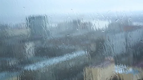 Window with dripping rain drops close-up Vidéo 88971153
