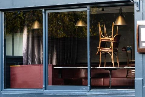 Window of an empty restaurant forced to close amid COVID-19 pandemic Stock Photos