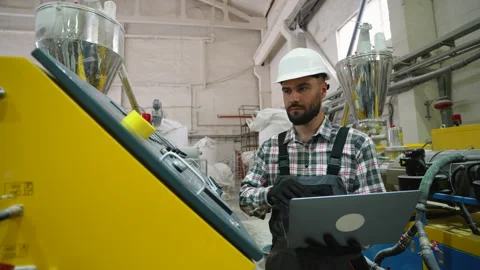 Window factory worker operating machinery with laptop Stock Footage 314583153