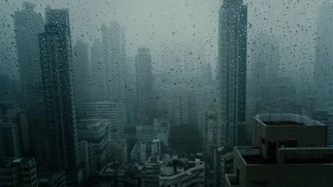 Window with falling rain at dusk in scryscraper. Stock Footage 93462872