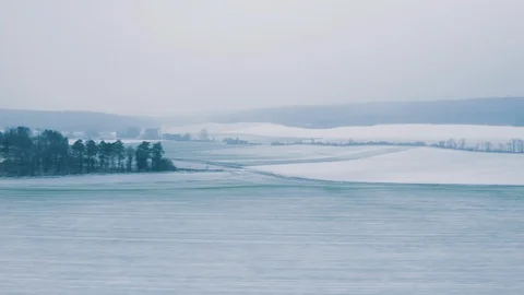 Window of a fast TGV ICE train over the frozen covered with snow French hills Stock Footage 101635855