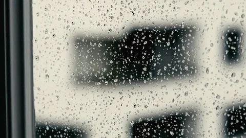 Window filled with falling rainy drops macro shot Video stock 73912930