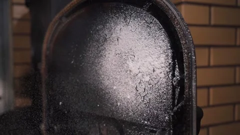 The window of the fireplace stove covered in black soot is sprayed with Stock Footage 323864344