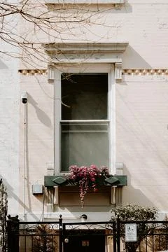 A window with a flower box in front of it Stock Photos