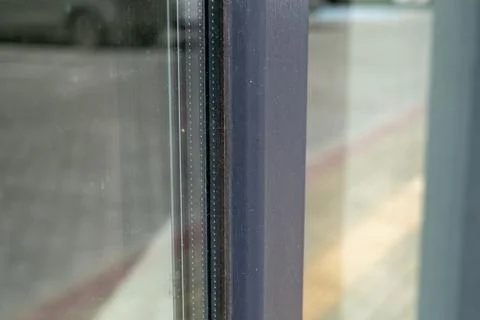 A window frame in a city has visible dirt and a clear reflection of surroun.. Stock Photos