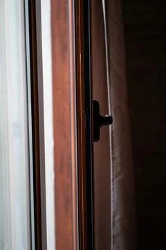Window frame with a dark handle, clear glass pane Stock Photos