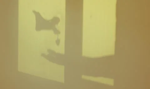 A window frame featuring an angel's silhouette and a woman's hand Stock Photos