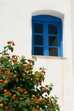 Window in front of the house wall. Specific vintage scene in Greece Stock Photos