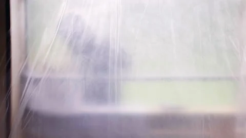 Window gap frame closed with transparent oilcloth after demolishing old windows Stock Footage 228684832