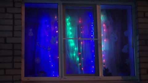 A window with a garland shines Stock Footage 159882114