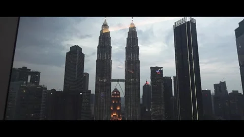Window glass view of twin tower kuala lumpur malaysia, cloudy evening Stock Footage 292975322
