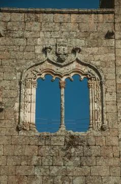 Window in gothic style on a stone wall Stock Photos