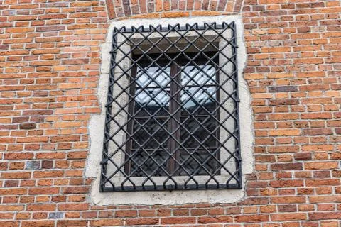 Window with Grate on Brick Wall Background Stock Photos
