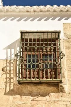Window with grating on the wall of old building Stock Photos