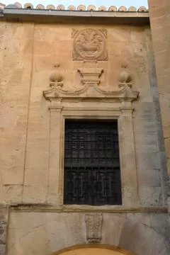 Window with grating on the wall of old building Stock Photos