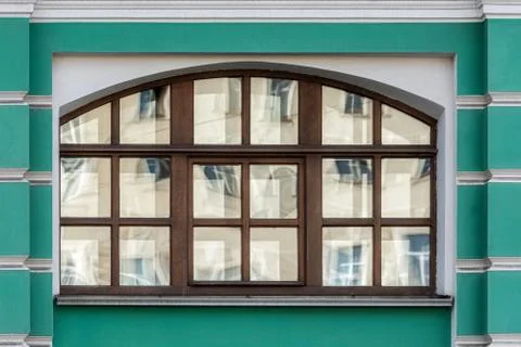 Window on a green wall. Stock Photos