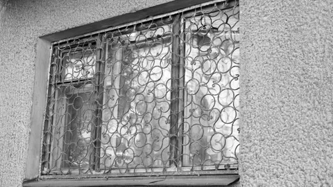 Window grille. An old, dilapidated window with a rusty iron window,animation Stock Footage 340794575