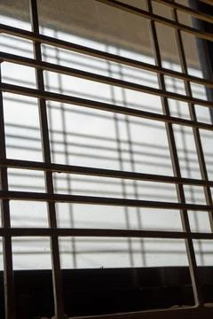 Window grille, view from inside, backlight. Stock Photos