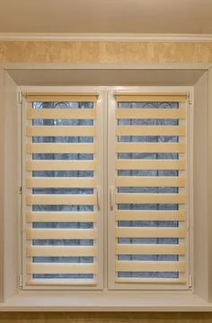 Window half closed with striped blinds day-night Stock Photos