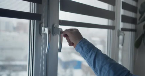 Window handle lock with key in man hands. Home safety window lock for baby Stock Footage 148433456