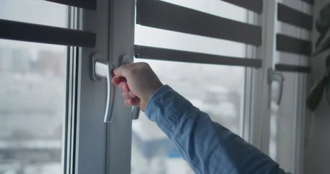 Window handle lock with key in man hands. Home safety window lock for baby Stock Footage 148433504