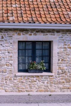 Window has small tiles. Stone house and roof tile Stock Photos