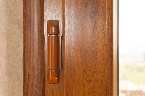 Window hinges Old Window hinges on a wooden color in an apartment, hinge repair. Stock Photos