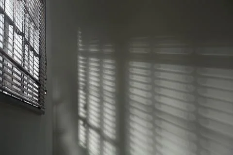 Window with horizontal blinds in room, space for text. Toned in black and whi Foto stock