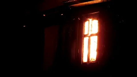 The window of the house is on fire, the night flame of the disaster. Stock Footage 330002402