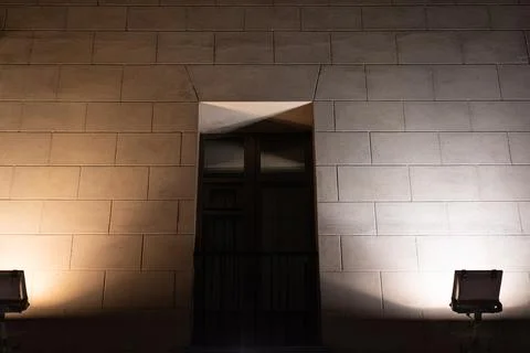 The window is illuminated at night from both sides by spotlights Stock Photos