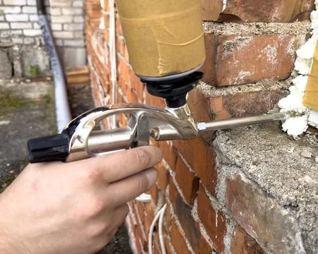 Window installation. The process of insulating windows with construction foam. A Stock Photos