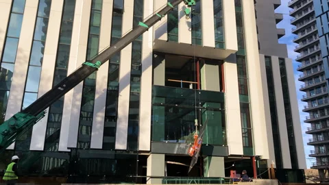 Window installation using a crane. Modern highrise building exterior Stock Footage 264807121