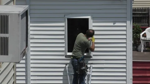 Window installer carpenter prepares house frame for a new glass panel Stock-Footage 115907807