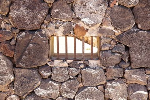 Window with iron bars on old facade with bricks Stock Photos