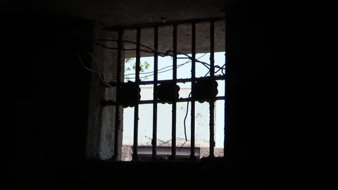 Window lattice in the prison cell. Small window at the dark with lattice Stock-Footage 84258169