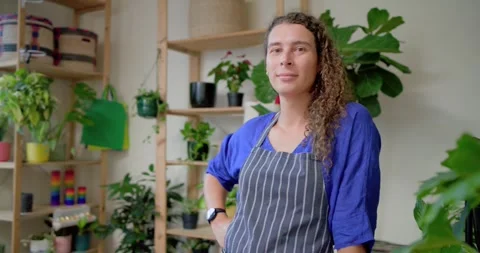 Window light urging African-American nonbinary owner turning smiling proud in Stock Footage 345072339
