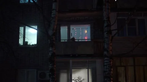 The window lights up with a garland Stock Footage 159882076