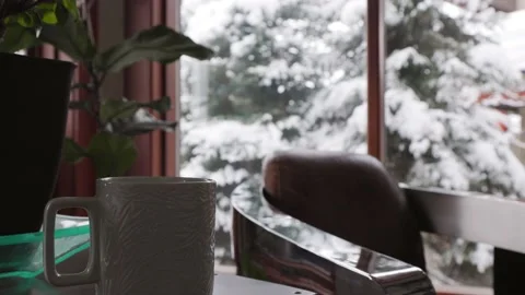 Window looking out to winter scene, hot cup of coffee, snowfall, winter Stock-Footage 239190874